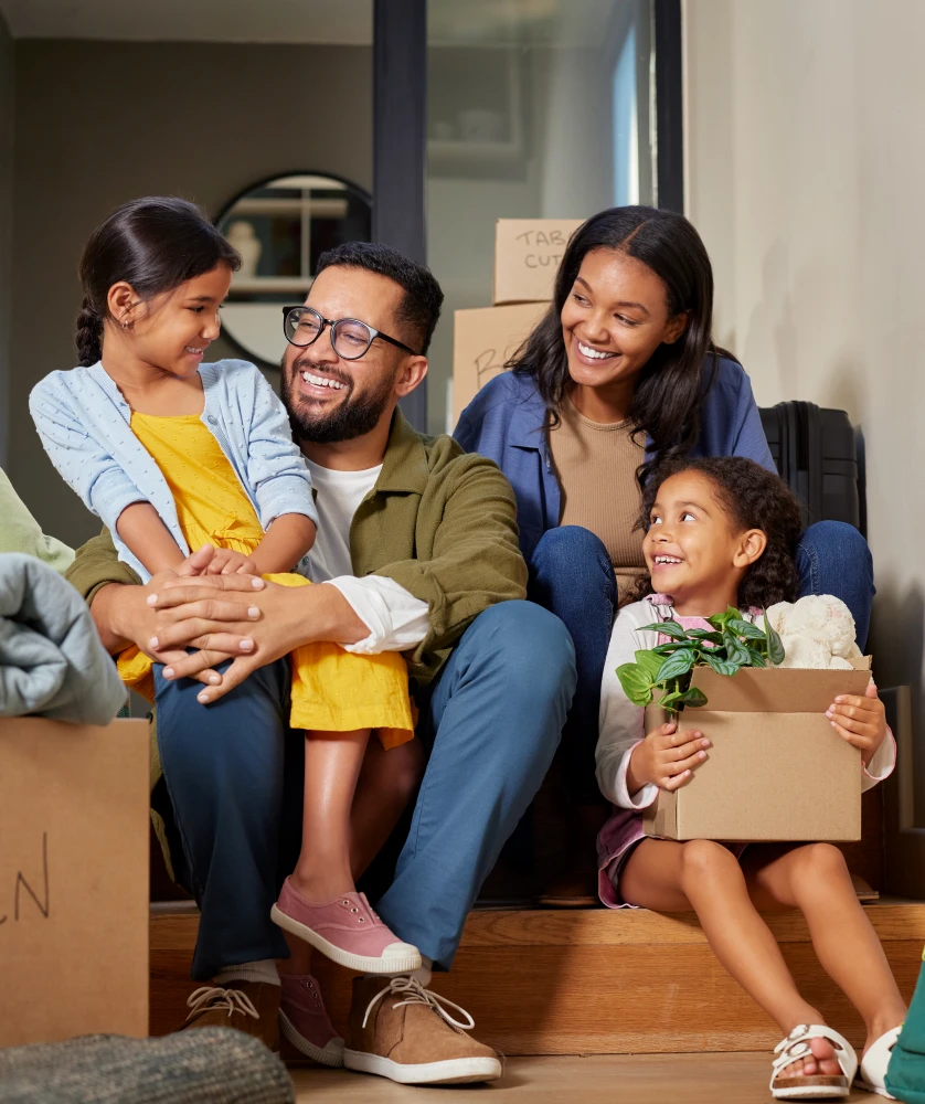 family moving into new home with cardboard boxes