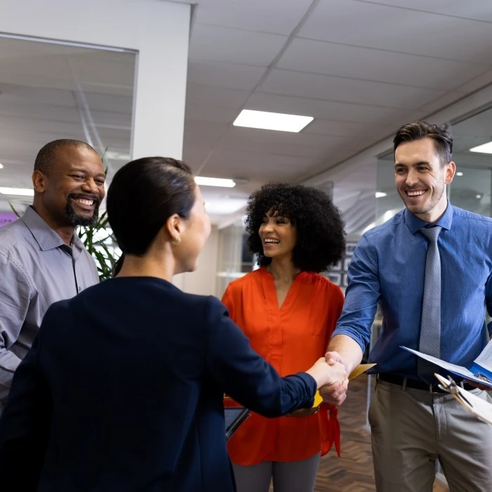 happy diverse female and male businesspeople talking and sharing information